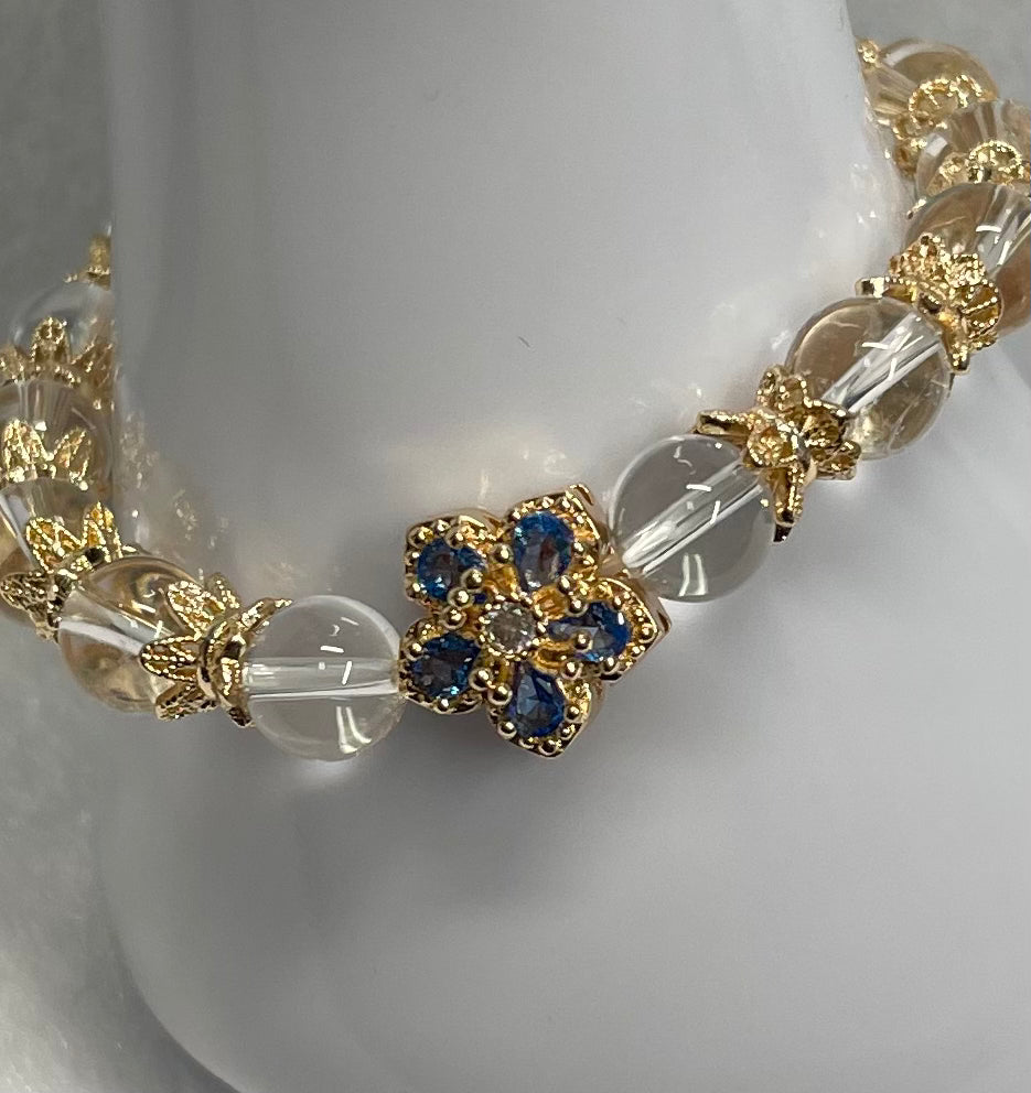 Blue and gold rhinestone bracelet with clear quartz beads.