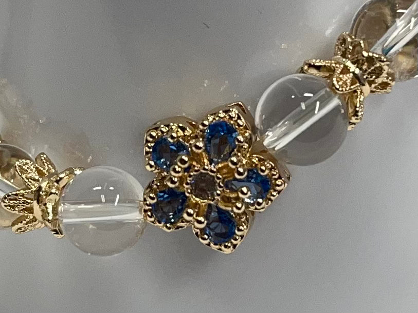 Blue and gold rhinestone bracelet with clear quartz beads.
